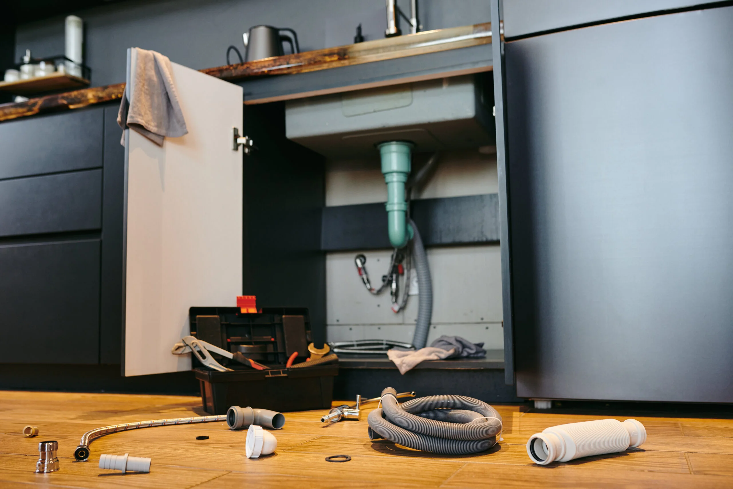 Kitchen disposal repair: tools, parts, and plumbing.